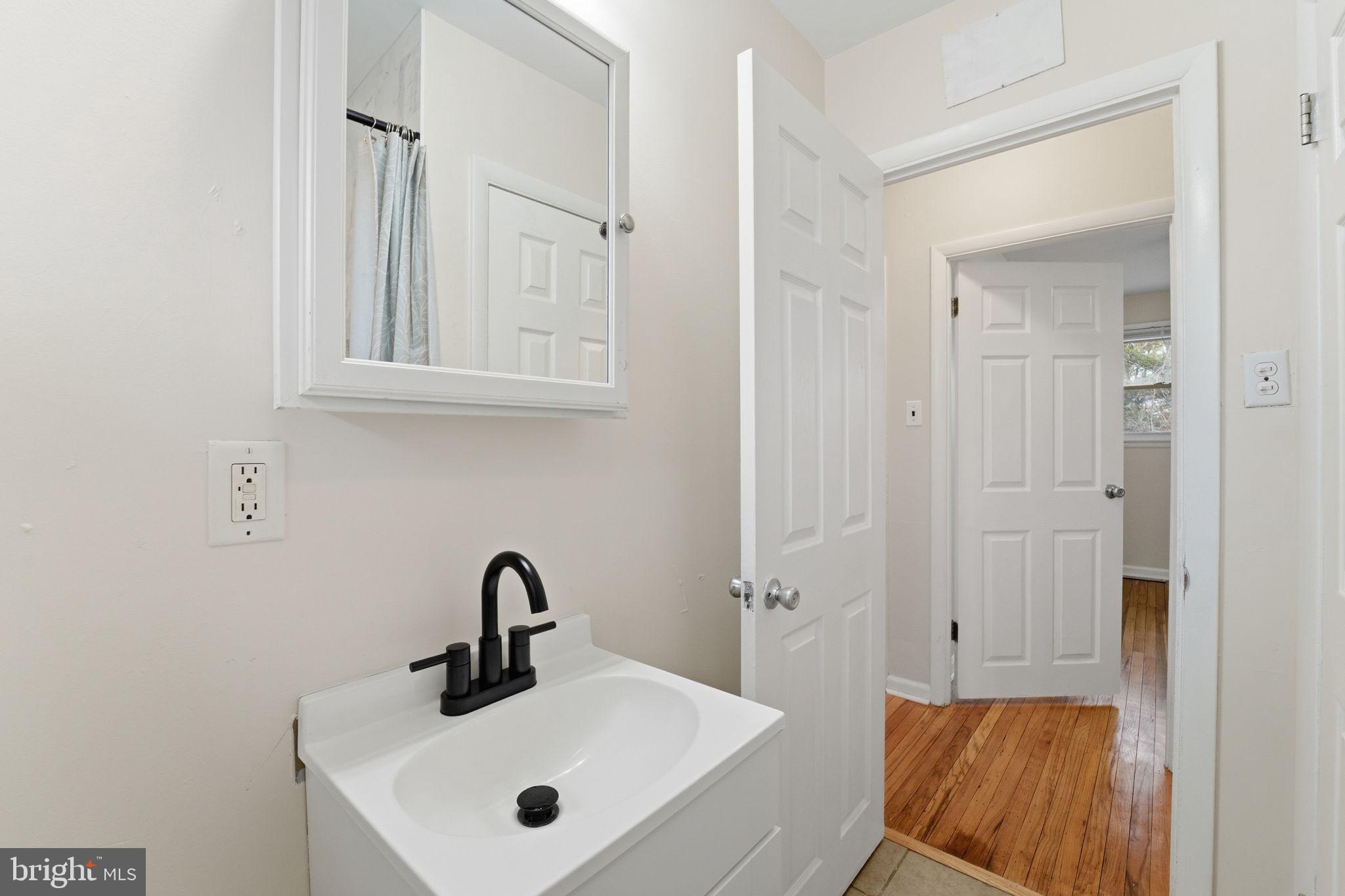 490 Hamilton Road Wenonah, NJ 08090 - Photo 31 of 49 a bathroom with a sink and a mirror
