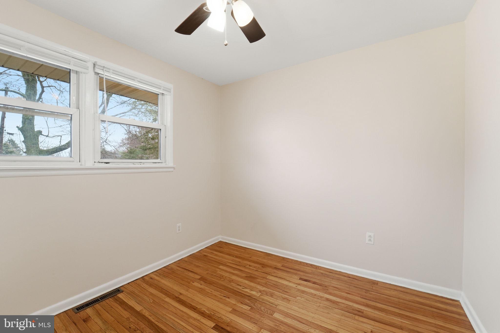490 Hamilton Road Wenonah, NJ 08090 - Photo 33 of 49 wooden floor in an empty room with a window