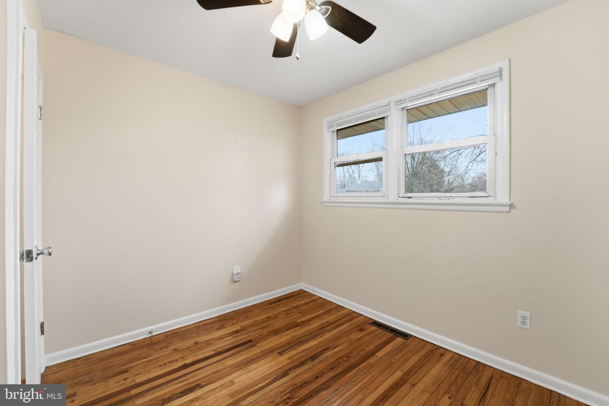490 Hamilton Road Wenonah, NJ 08090 - Photo 34 of 49 an empty room with a window and wooden floor