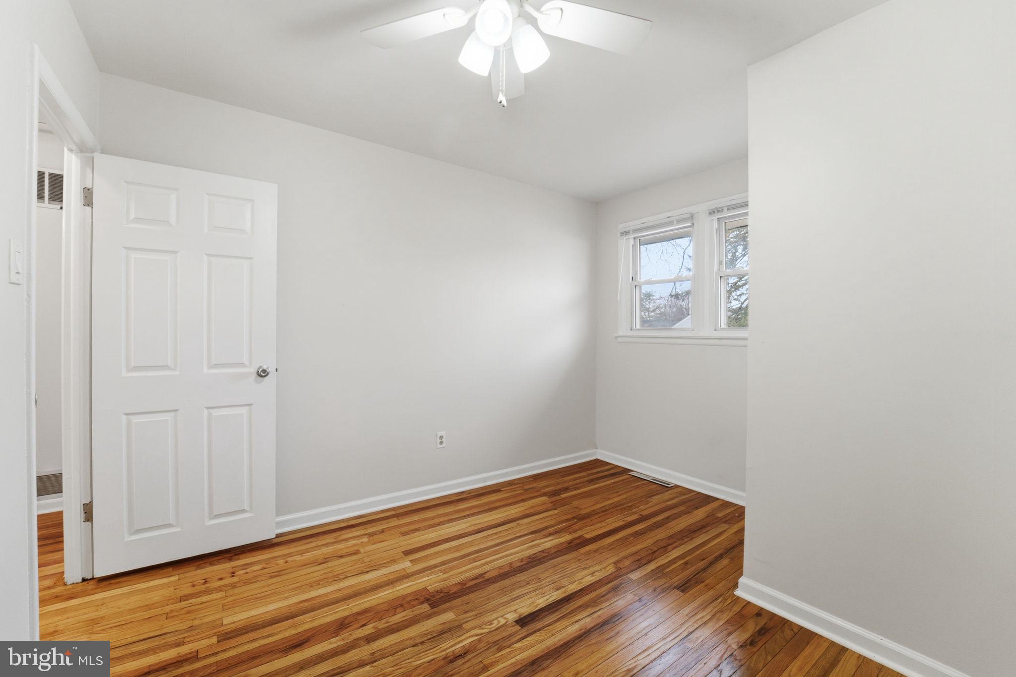 490 Hamilton Road Wenonah, NJ 08090 - Photo 44 of 49 a room with a bed and a chandelier fan