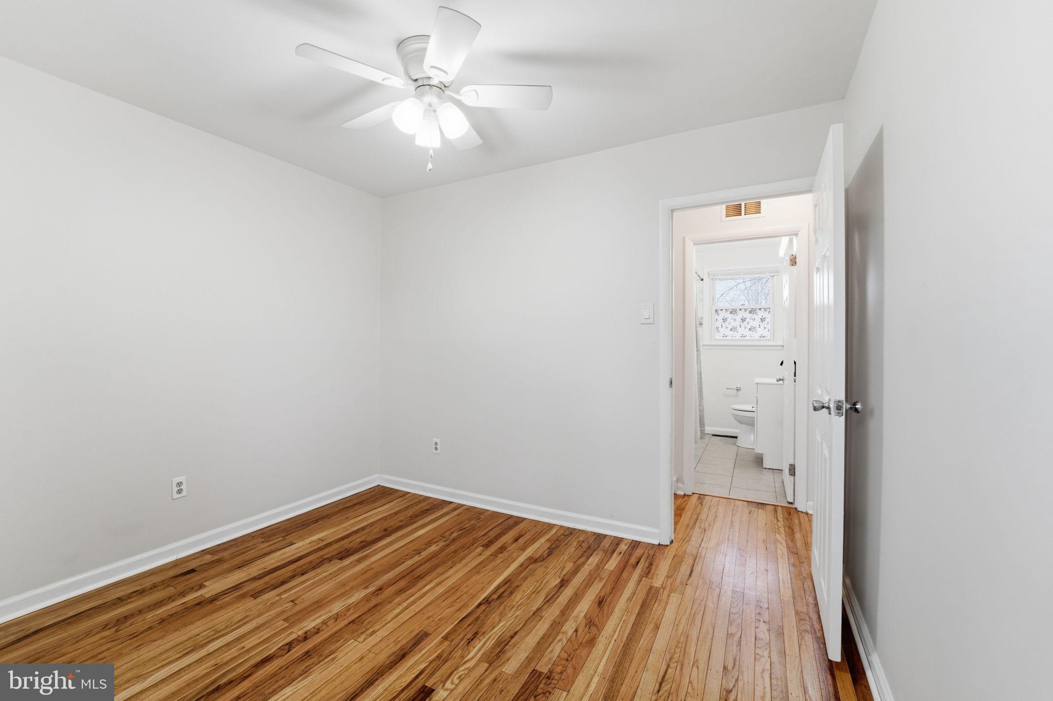 490 Hamilton Road Wenonah, NJ 08090 - Photo 45 of 49 a view of a room with wooden floor and a ceiling fan
