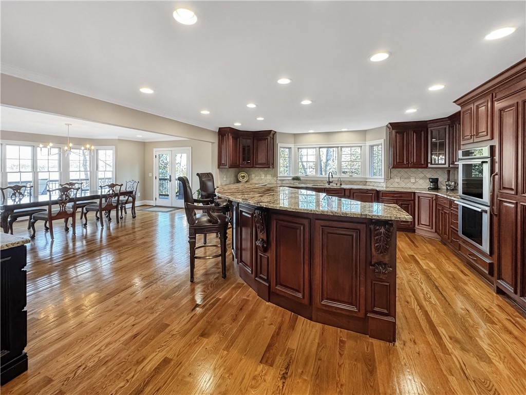 26 Beacon Ridge Circle Salem, SC 29676 - Photo 17 of 46 This kitchen and dining area features rich wood cabinetry and gleaming hardwood flooring.
