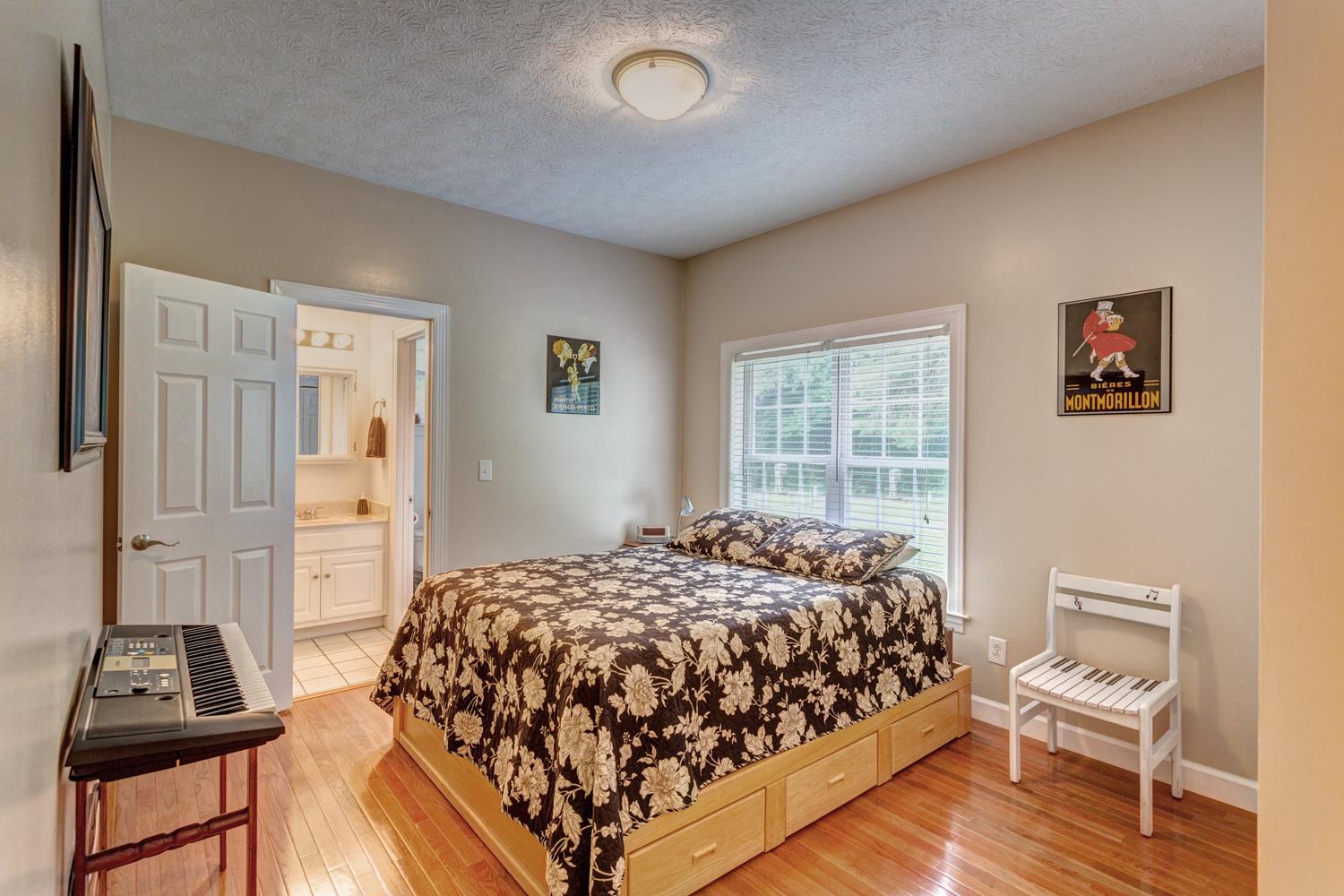 7571 Webster Road White House, TN 37188 - Photo 16 of 30 a bedroom with a bed and wooden floor