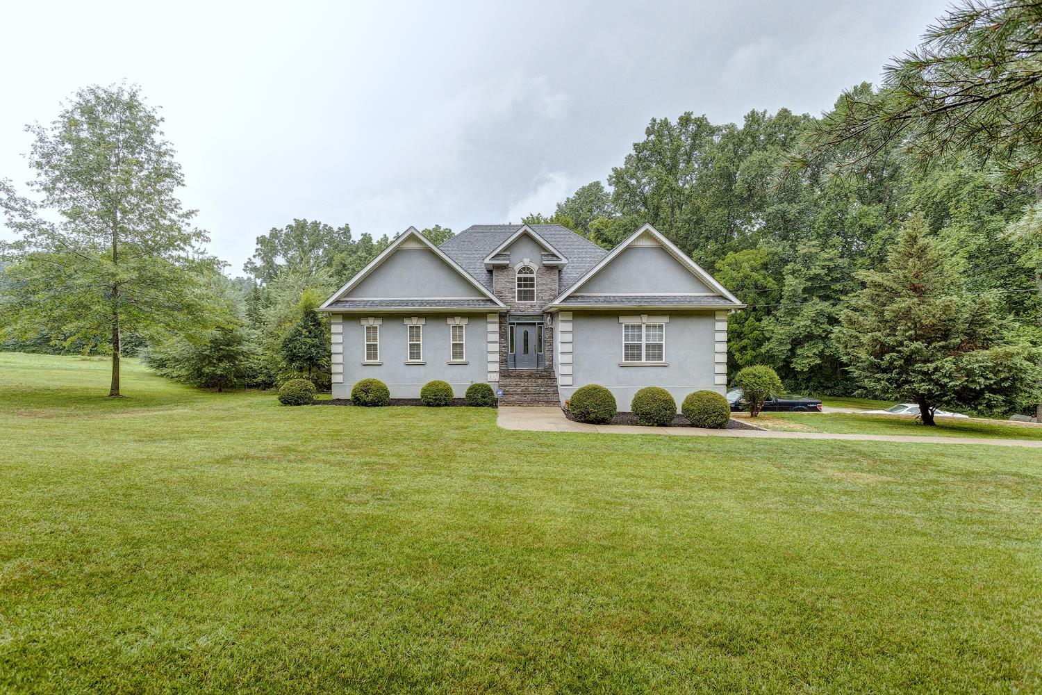 7571 Webster Road White House, TN 37188 - Photo 2 of 30 a view of a house with a big yard and large trees