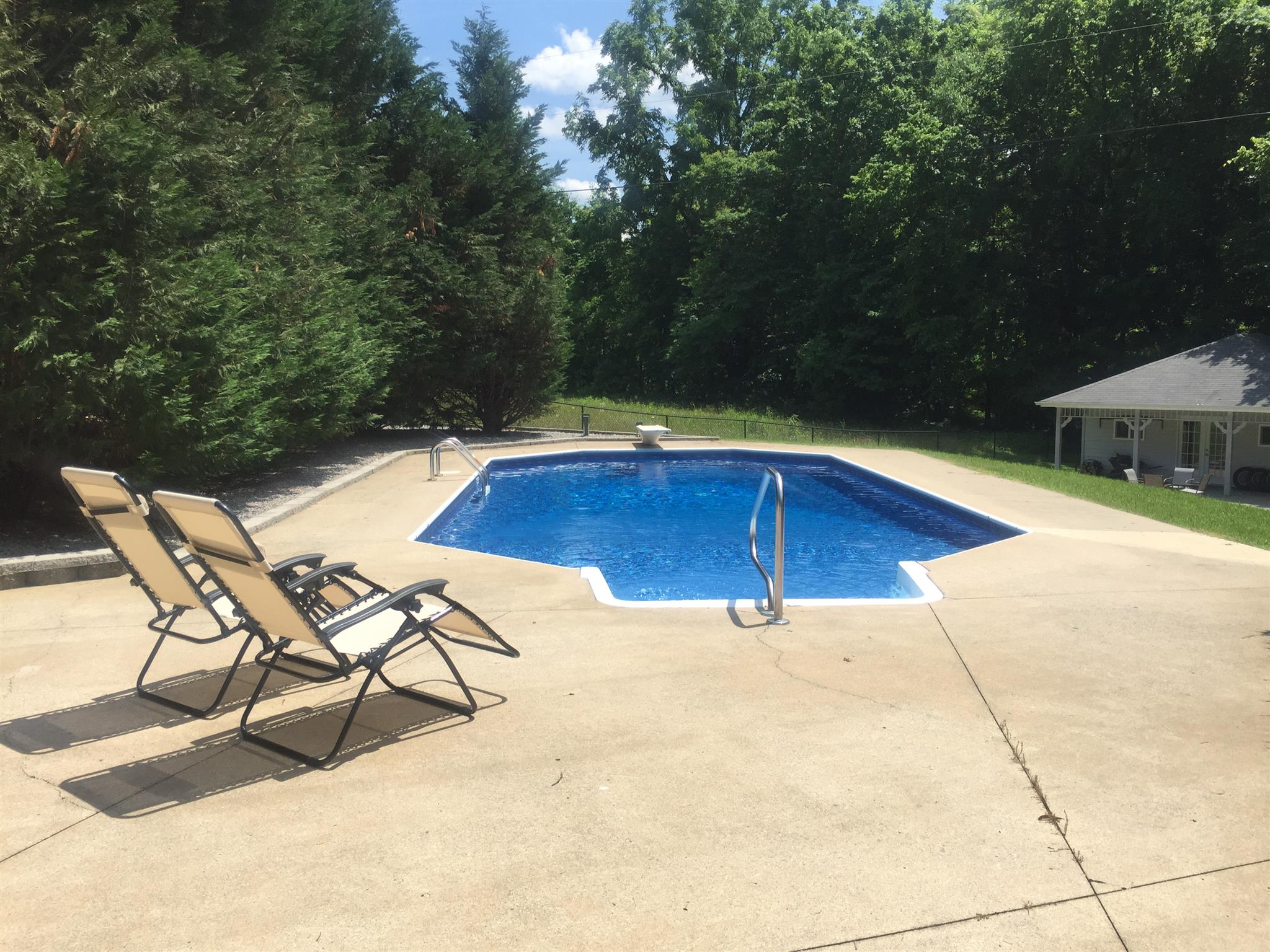 7571 Webster Road White House, TN 37188 - Photo 29 of 30 a view of swimming pool with seating area and trees