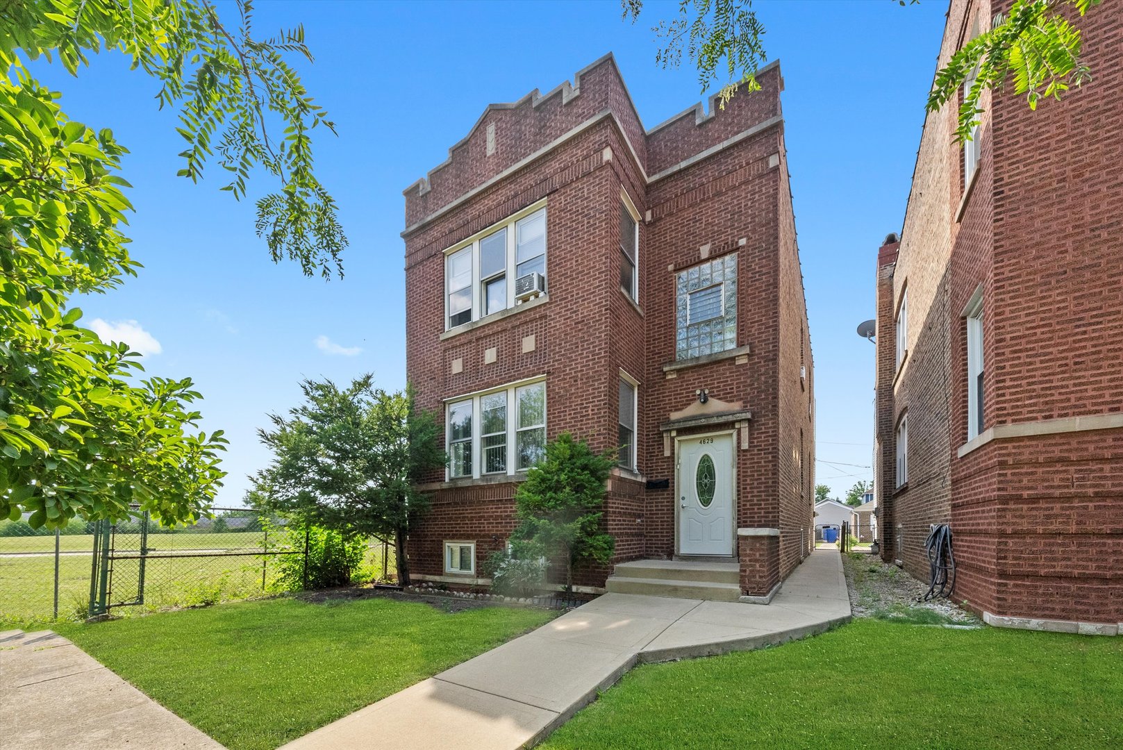 a view of a brick building next to a yard