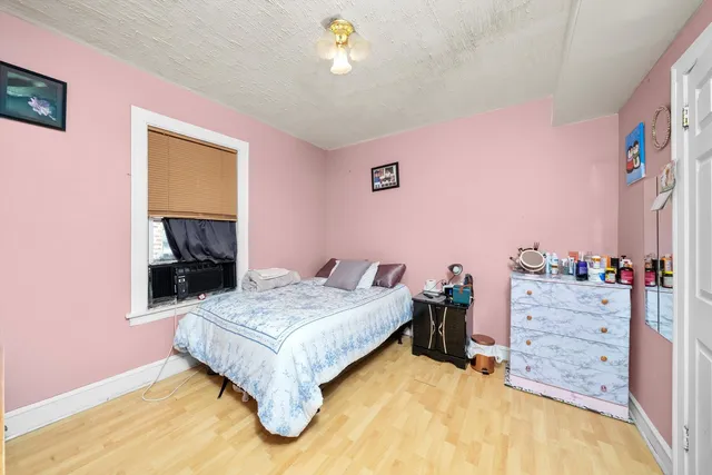 a bedroom with a bed and dresser