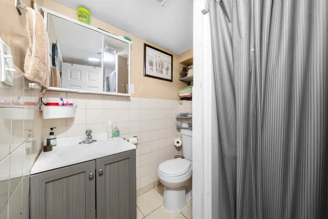 a bathroom with a toilet a sink and a mirror