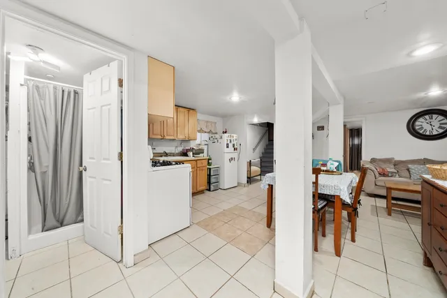 a view of kitchen with furniture and refrigerator