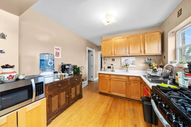 a kitchen with stainless steel appliances a stove a sink and a refrigerator