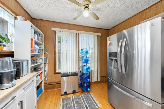 a view of a kitchen with furniture and a ceiling fan