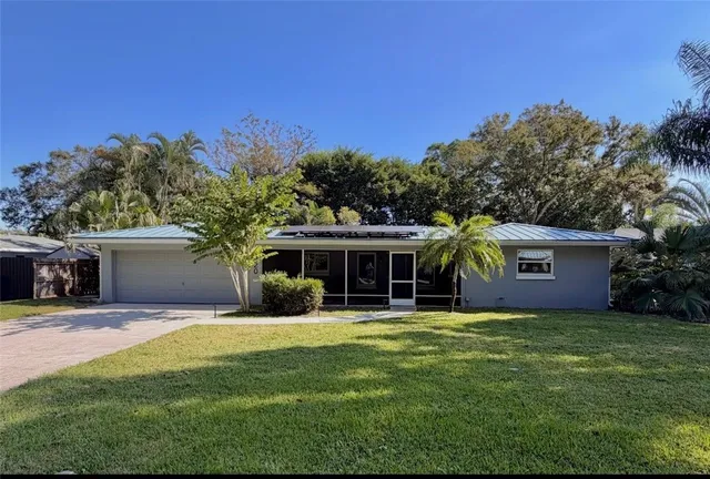 a front view of house with yard and green space