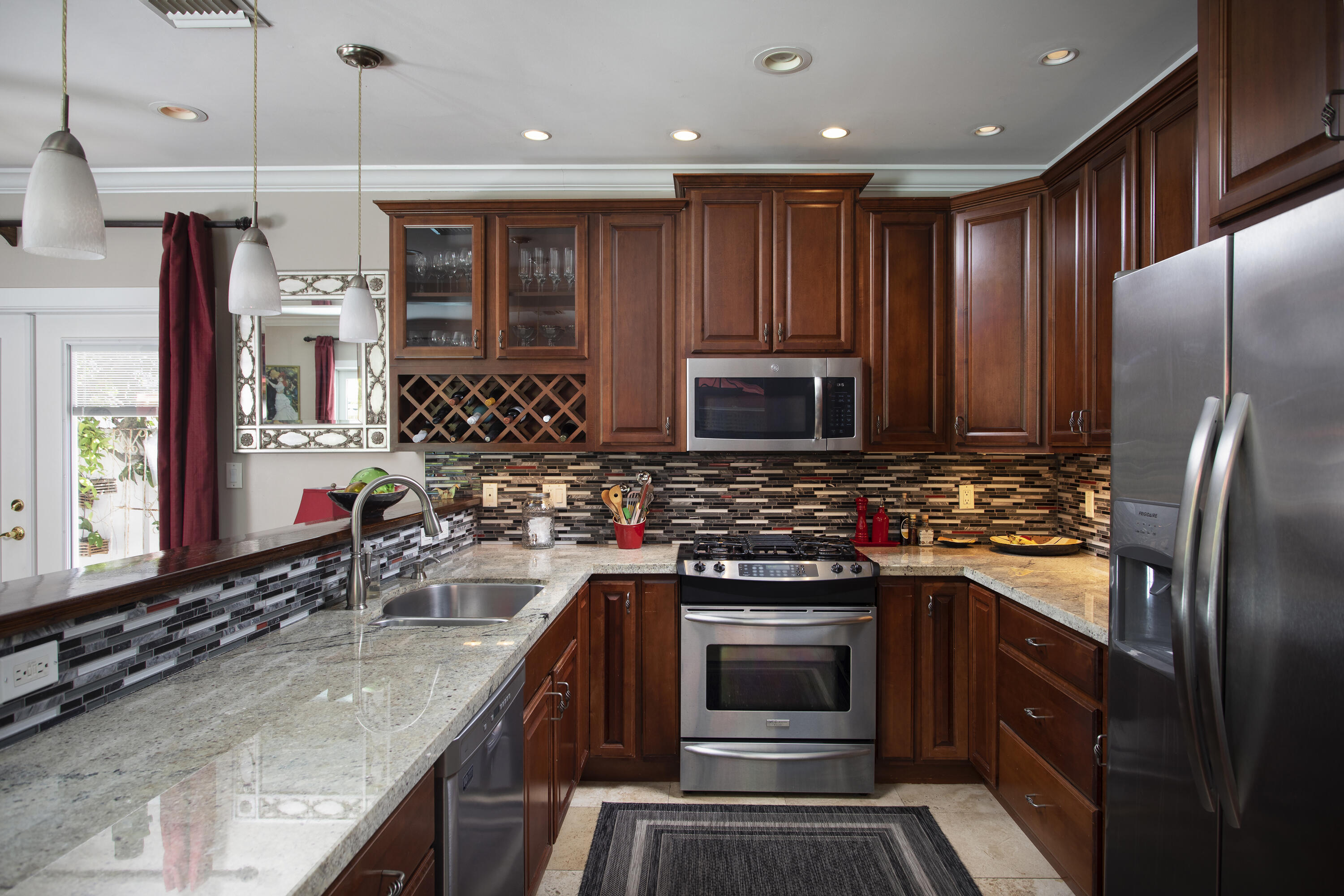 1506 South Street Key West, FL 33040 - Photo 12 of 27 a kitchen with stainless steel appliances granite countertop a stove and a sink