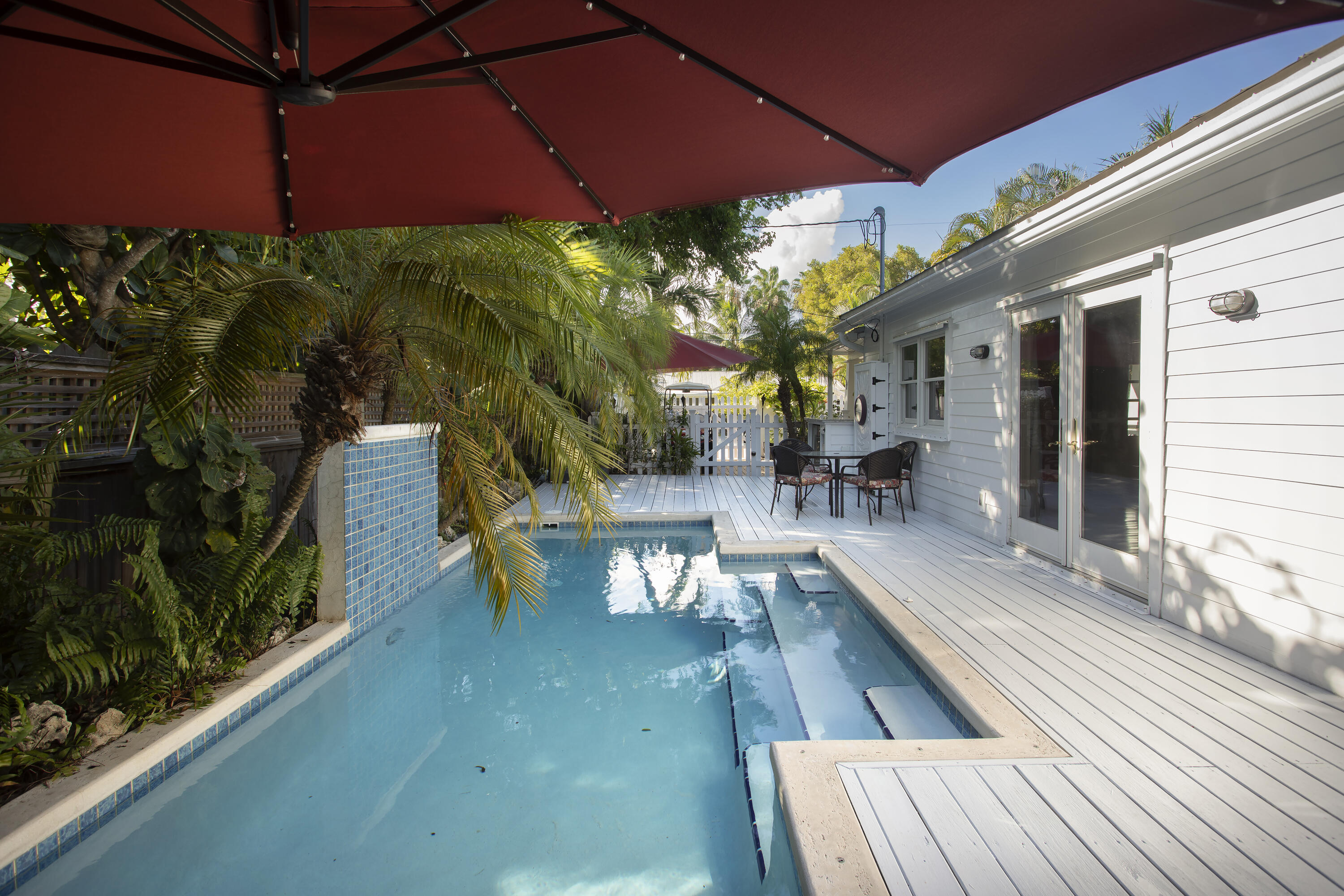 1506 South Street Key West, FL 33040 - Photo 15 of 27 a view of a patio with table and chairs under an umbrella