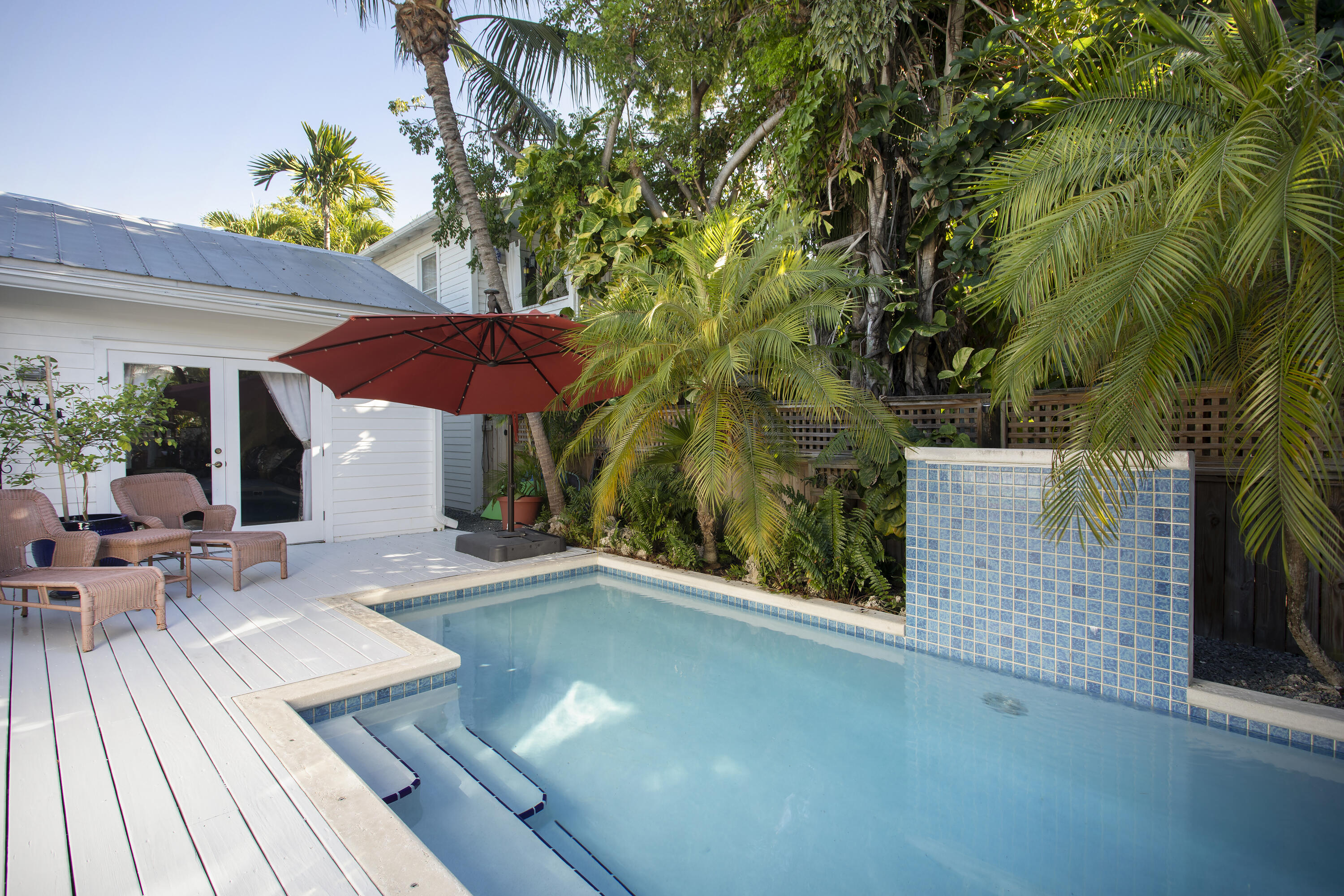 1506 South Street Key West, FL 33040 - Photo 24 of 27 a view of a patio with chairs and potted plants