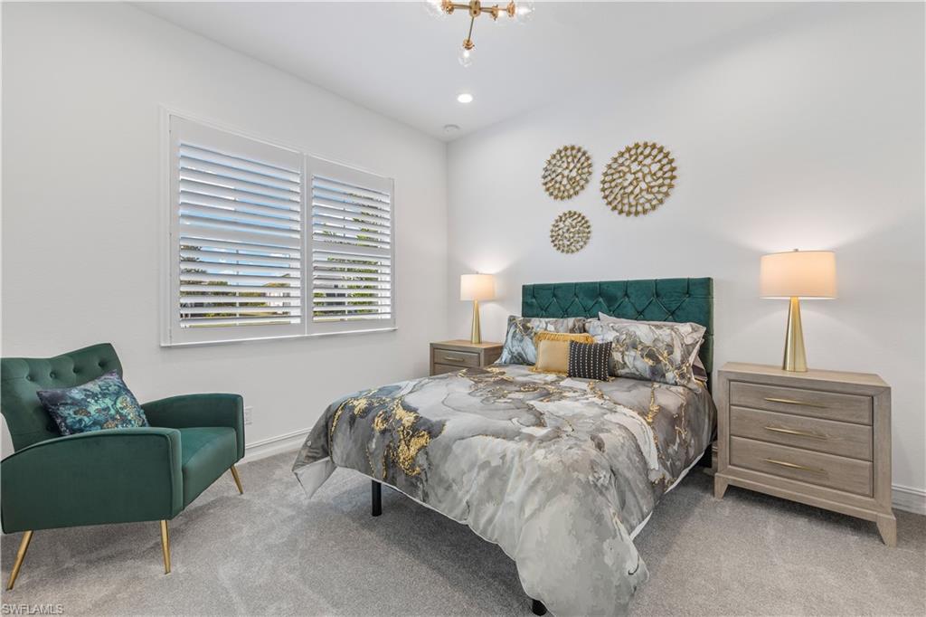 14265 Laguna Springs Lane Naples, FL 34114 - Photo 17 of 40 a bedroom with a bed and a couch