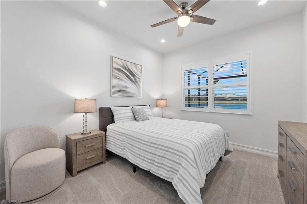 14265 Laguna Springs Lane Naples, FL 34114 - Photo 21 of 40 a bedroom with a bed and window