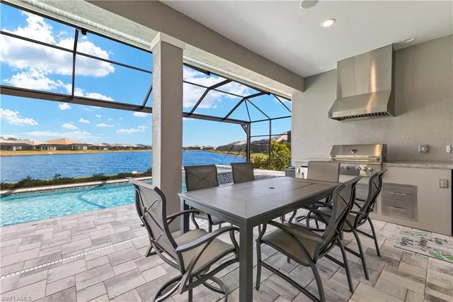 a view of a balcony with chairs and an umbrella