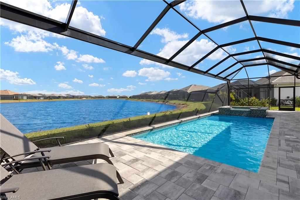 14265 Laguna Springs Lane Naples, FL 34114 - Photo 25 of 40 a view of a backyard with sitting area