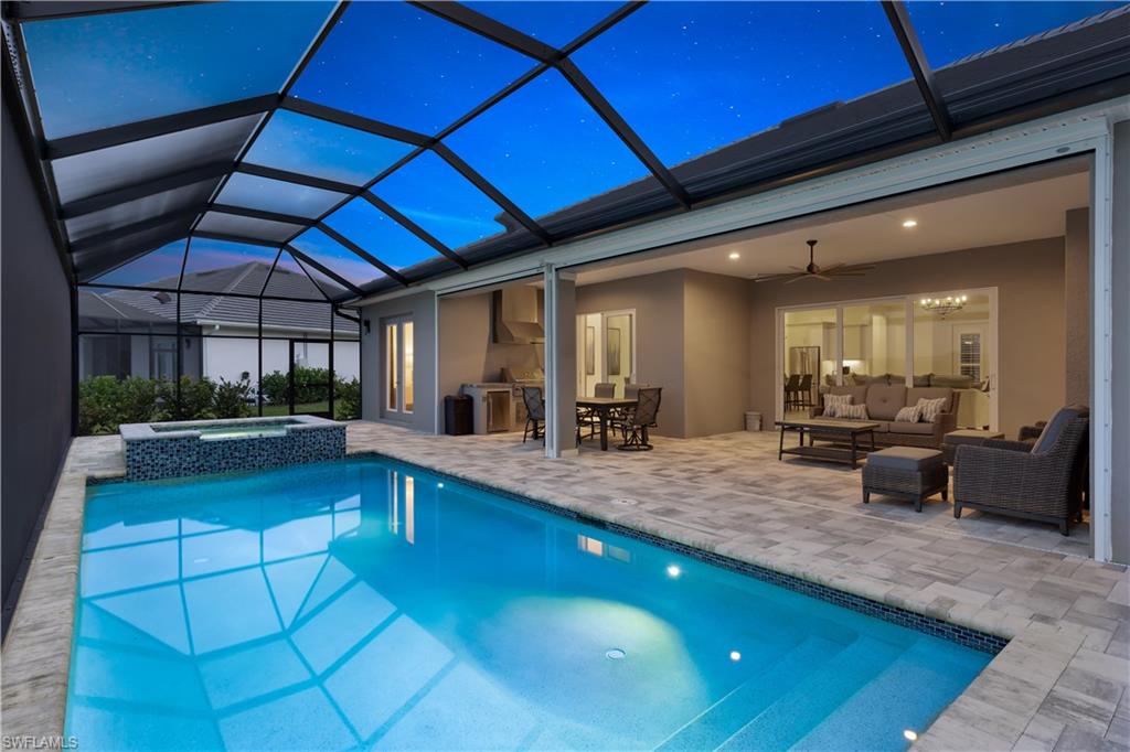 14265 Laguna Springs Lane Naples, FL 34114 - Photo 27 of 40 a large swimming pool with a outdoor seating
