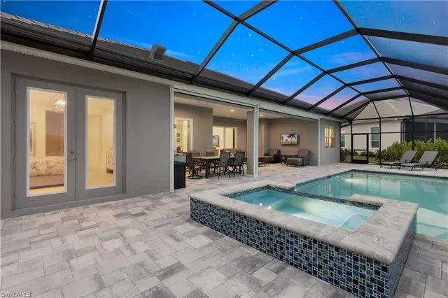 a living room with furniture a rug and a floor to ceiling window