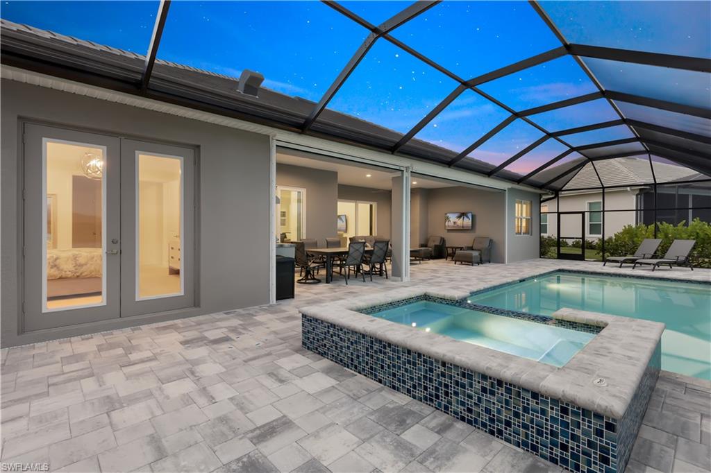 14265 Laguna Springs Lane Naples, FL 34114 - Photo 29 of 40 a view of swimming pool with outdoor seating