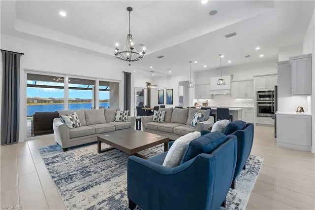 a kitchen with stainless steel appliances kitchen island granite countertop a table chairs sink and cabinets