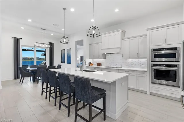 a view of a dining room with furniture a chandelier and wooden floor