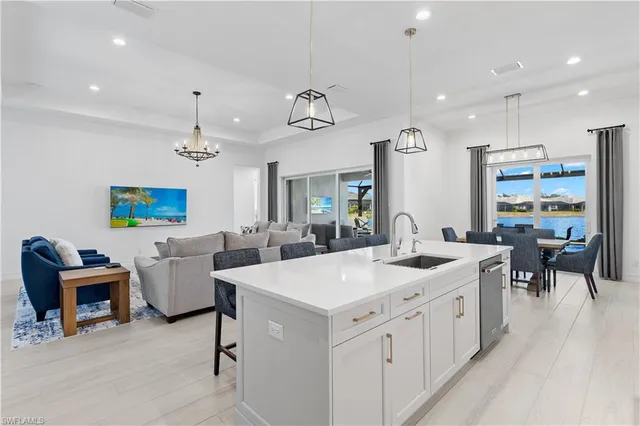 a kitchen with white cabinets and window
