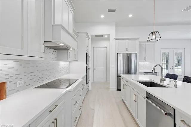a living room with furniture a chandelier and a dining table