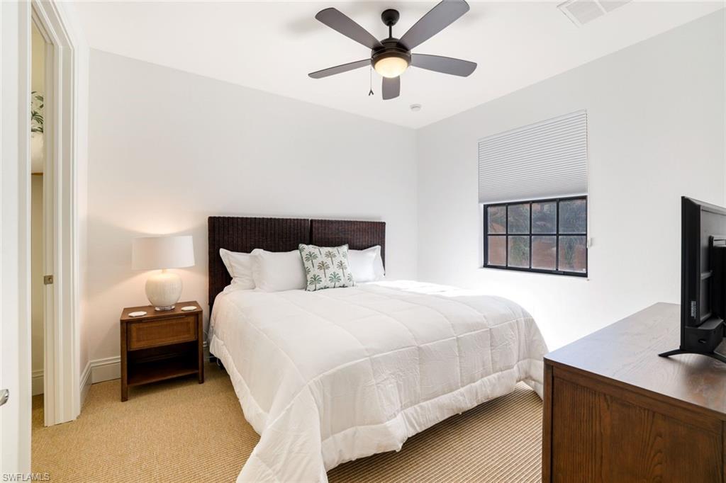 9072 Rialto Street, Unit 6302 Naples, FL 34113 - Photo 11 of 17 Bedroom with light carpet and a ceiling fan