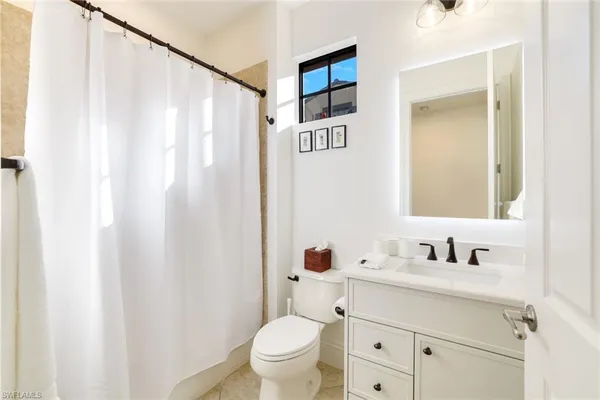 a bedroom with two beds and a window