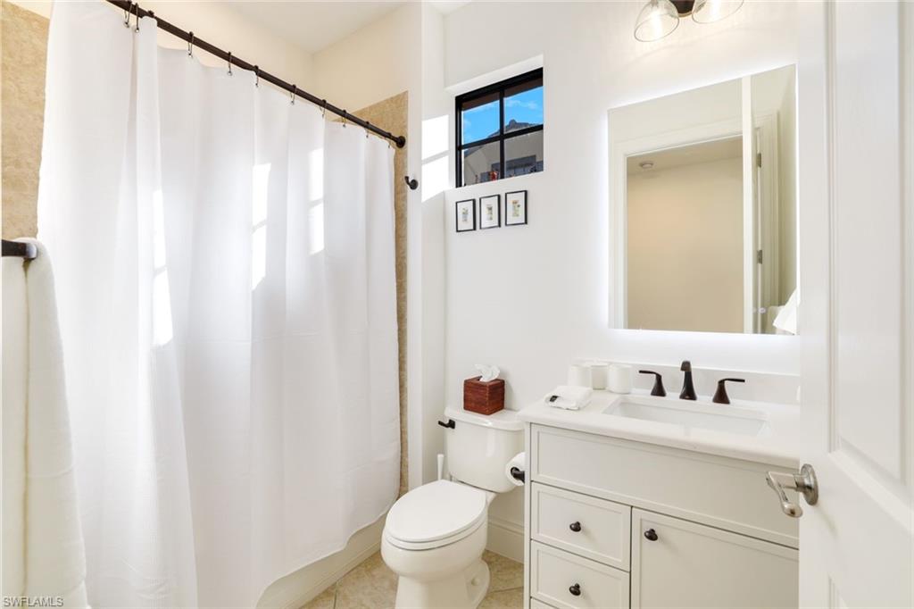 9072 Rialto Street, Unit 6302 Naples, FL 34113 - Photo 13 of 17 Bathroom featuring vanity and a shower with curtain