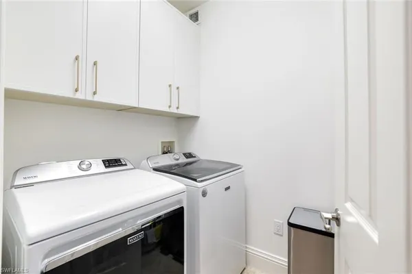 a view of a dining room with furniture large windows and a livingroom
