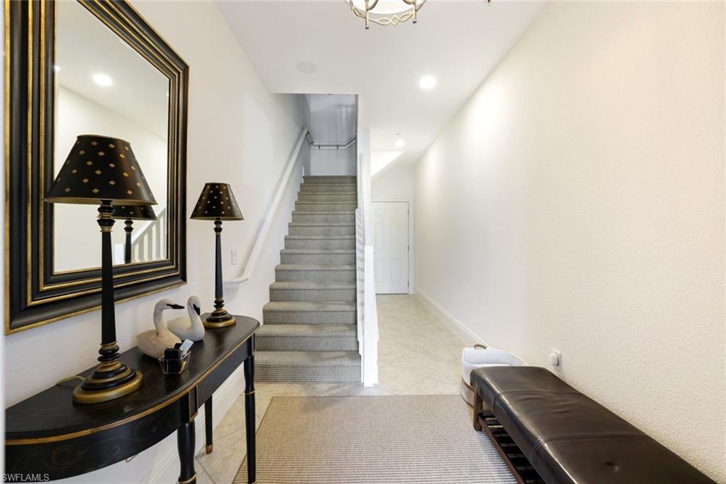 9072 Rialto Street, Unit 6302 Naples, FL 34113 - Photo 2 of 17 Staircase featuring recessed lighting and tile patterned floors