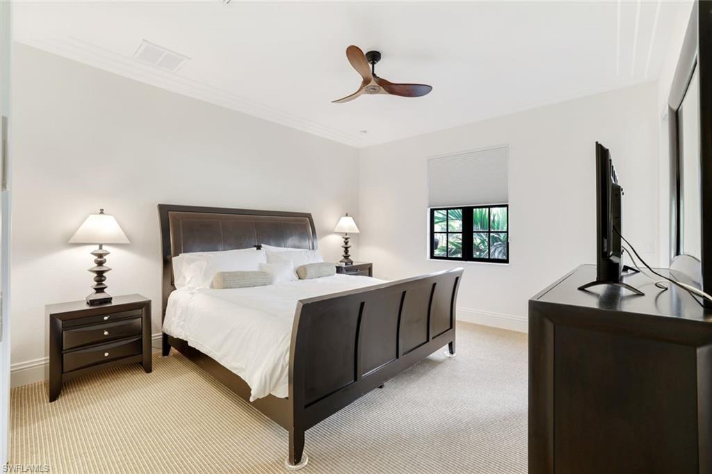 9072 Rialto Street, Unit 6302 Naples, FL 34113 - Photo 7 of 17 Bedroom with light colored carpet, a ceiling fan, and crown molding