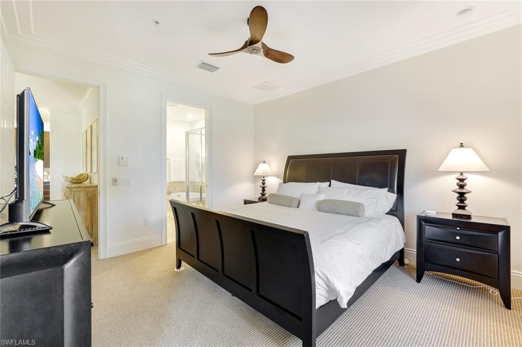 9072 Rialto Street, Unit 6302 Naples, FL 34113 - Photo 8 of 17 Bedroom with crown molding, light carpet, ceiling fan, and connected bathroom
