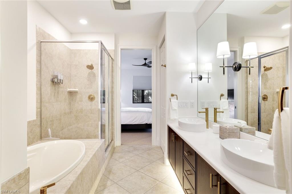 9072 Rialto Street, Unit 6302 Naples, FL 34113 - Photo 10 of 17 Full bathroom featuring connected bathroom, a stall shower, a garden tub, double vanity, and ceiling fan
