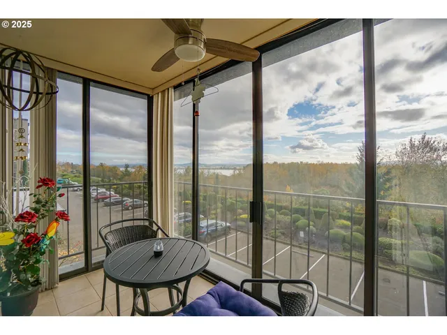 a balcony with chairs and glass door