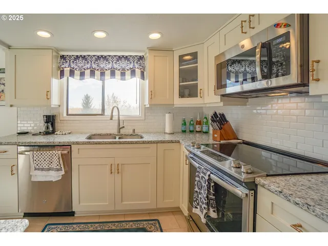 a kitchen with a sink stove and cabinets