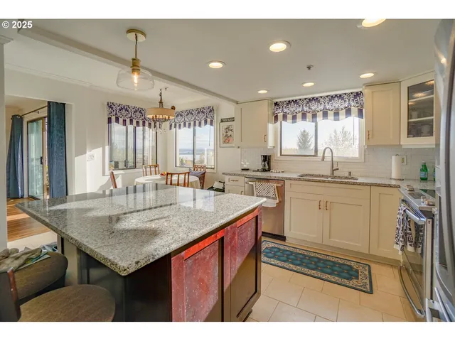 a kitchen with a sink window and cabinets