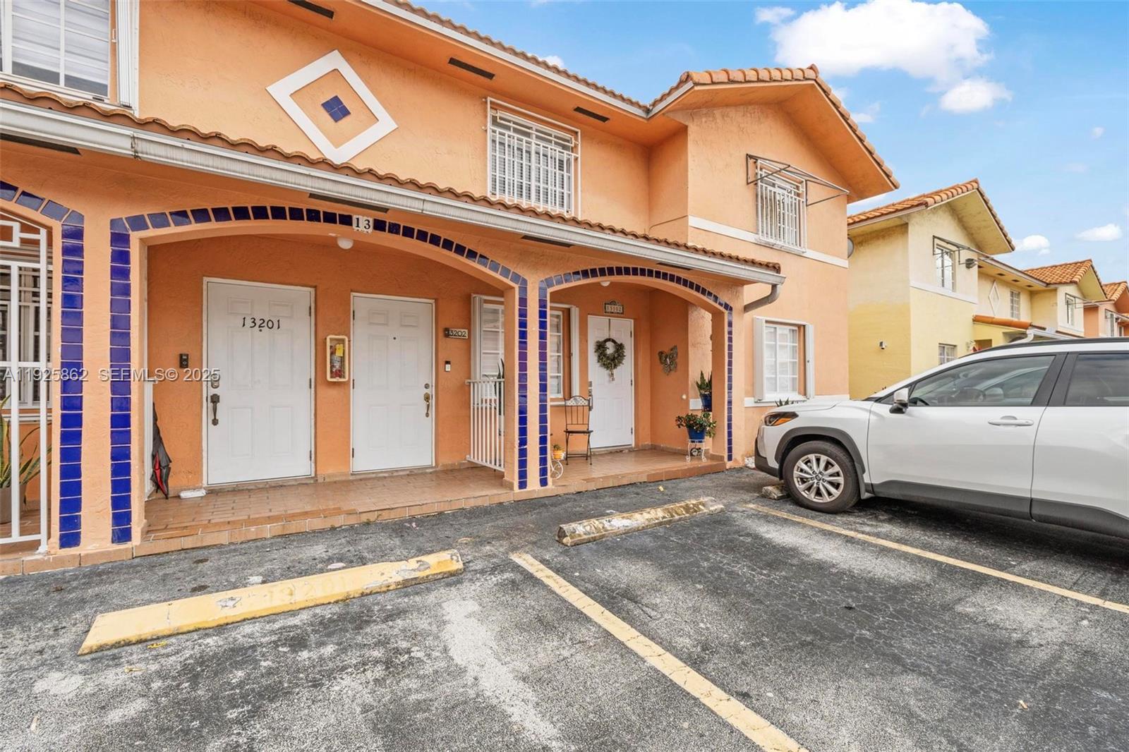 10101 West Okeechobee Road, Unit 13202 Hialeah Gardens, FL 33016 - Photo 12 of 30 a view of a car park in front of a building