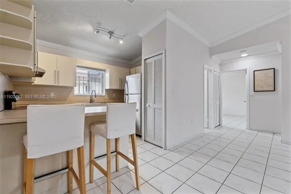 a kitchen with a sink a stove a table and chairs