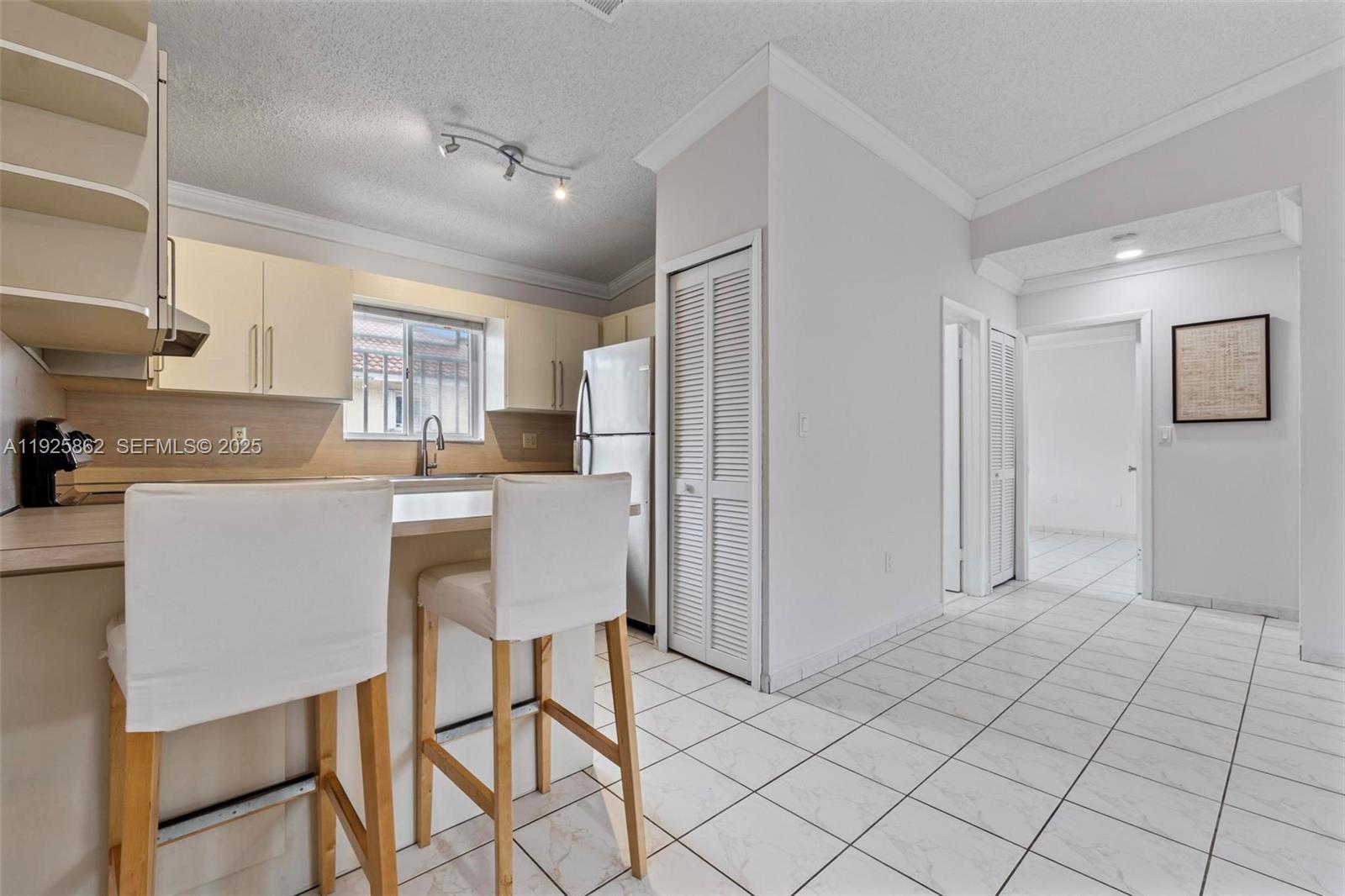 10101 West Okeechobee Road, Unit 13202 Hialeah Gardens, FL 33016 - Photo 14 of 30 a kitchen with stainless steel appliances kitchen island granite countertop a refrigerator and a stove top oven
