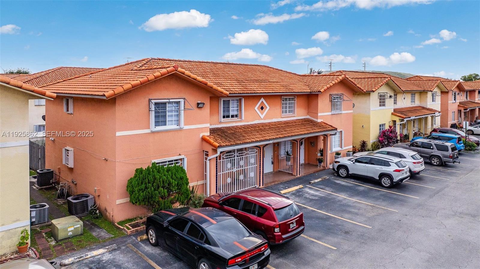 10101 West Okeechobee Road, Unit 13202 Hialeah Gardens, FL 33016 - Photo 2 of 30 a car parked in front of a house