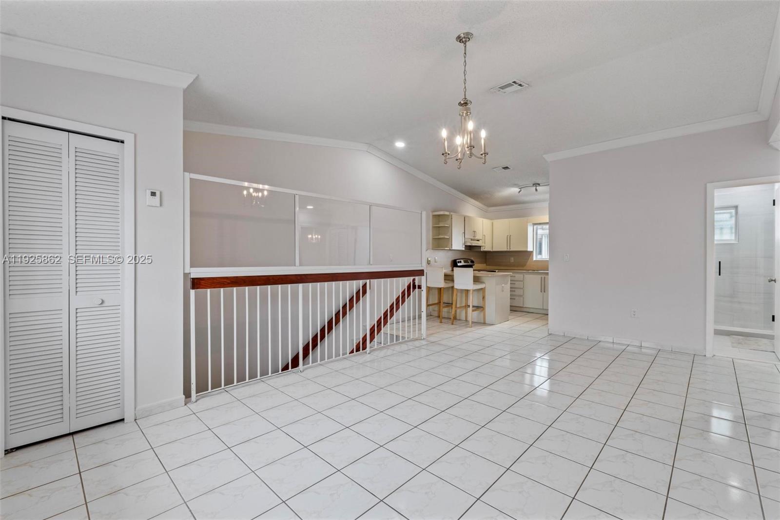 10101 West Okeechobee Road, Unit 13202 Hialeah Gardens, FL 33016 - Photo 21 of 30 a view of a kitchen and an empty room
