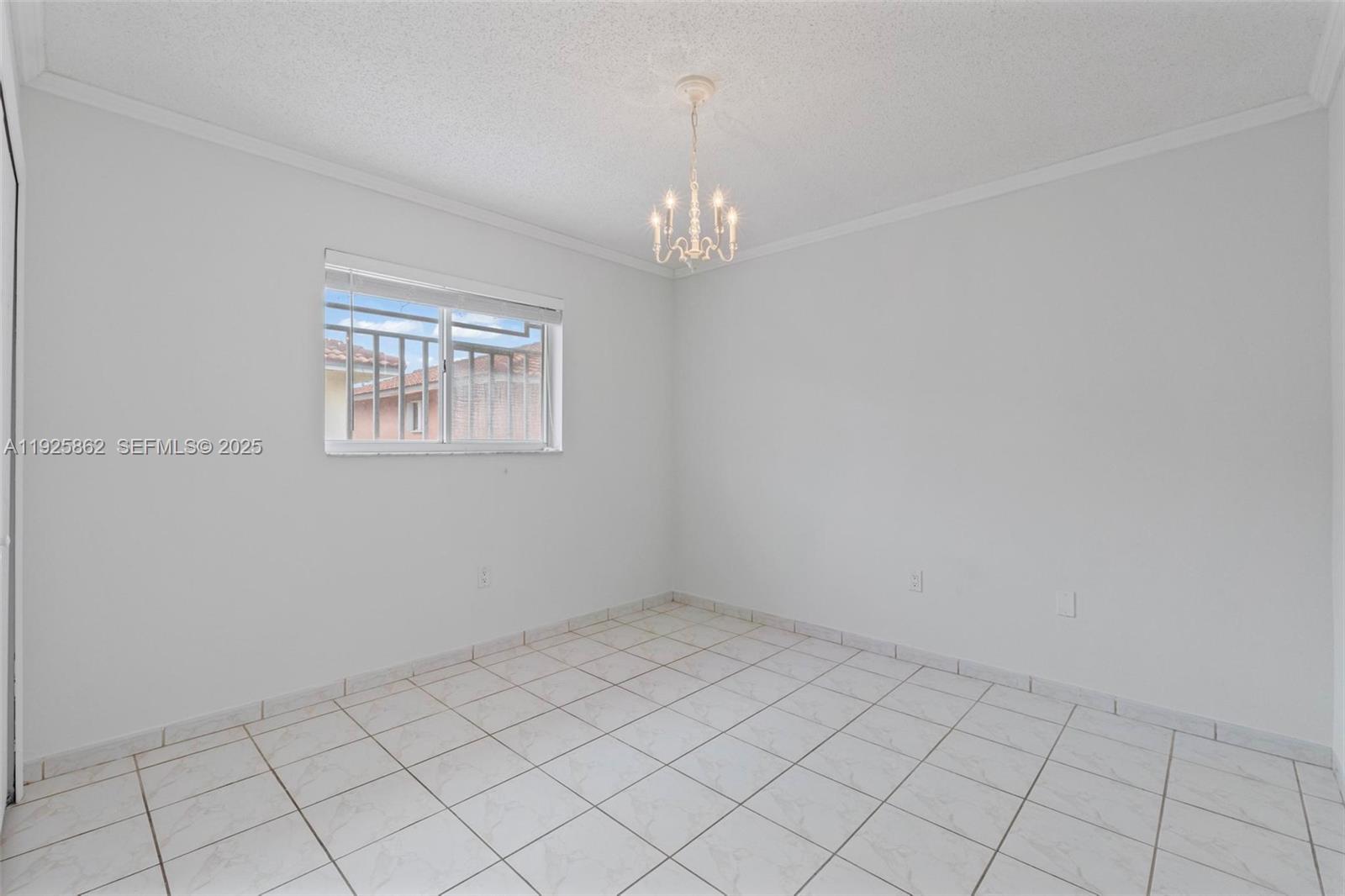 10101 West Okeechobee Road, Unit 13202 Hialeah Gardens, FL 33016 - Photo 23 of 30 an empty room with chandelier fan