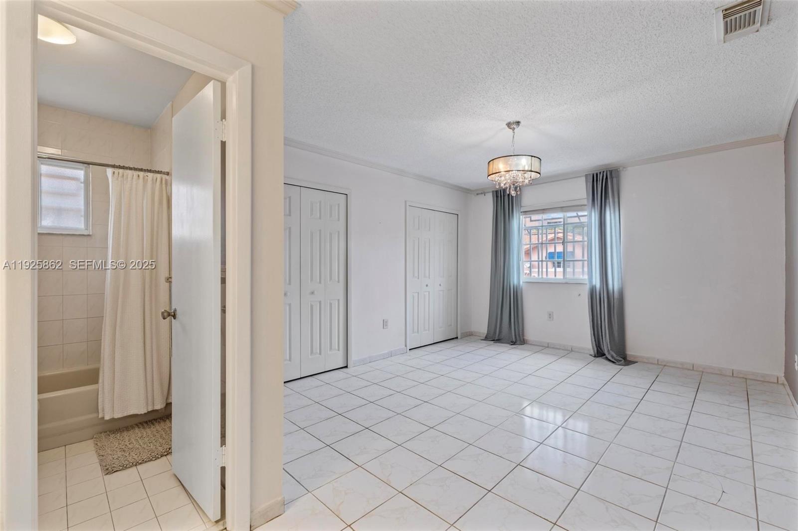 10101 West Okeechobee Road, Unit 13202 Hialeah Gardens, FL 33016 - Photo 25 of 30 an empty room with windows and closet