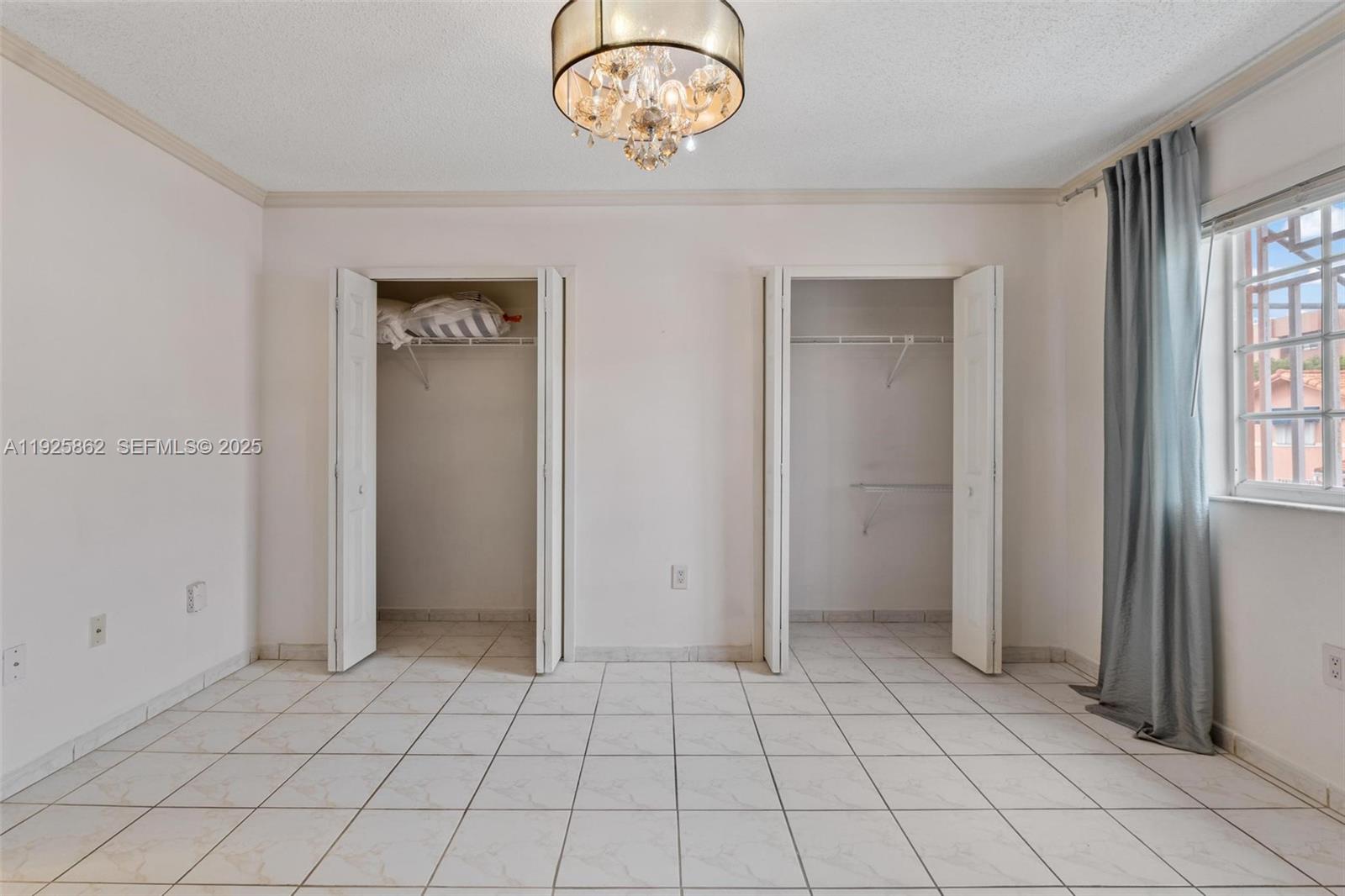 10101 West Okeechobee Road, Unit 13202 Hialeah Gardens, FL 33016 - Photo 27 of 30 an empty room with windows and closet