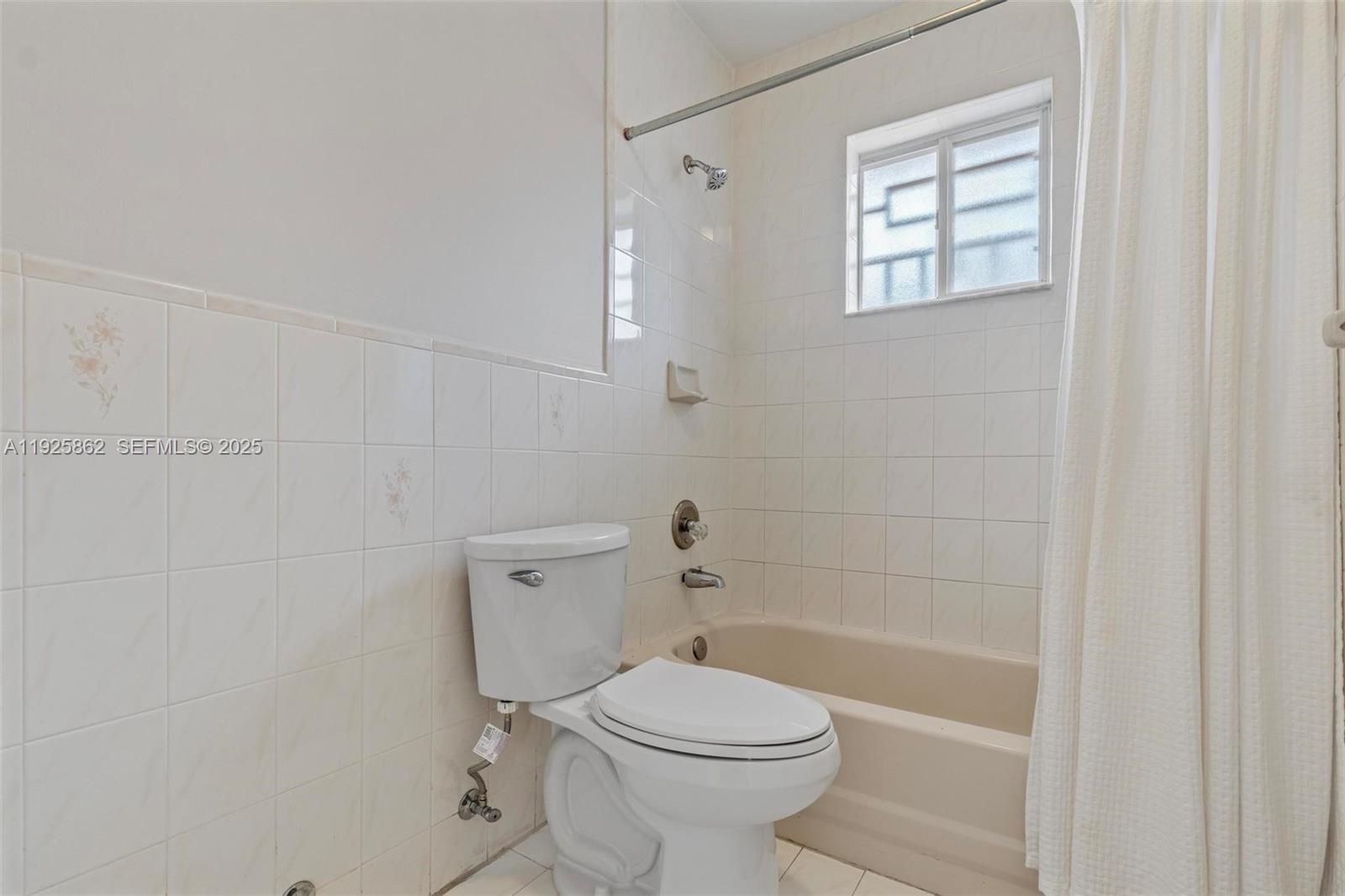 10101 West Okeechobee Road, Unit 13202 Hialeah Gardens, FL 33016 - Photo 29 of 30 a white toilet sitting next to a bath tub